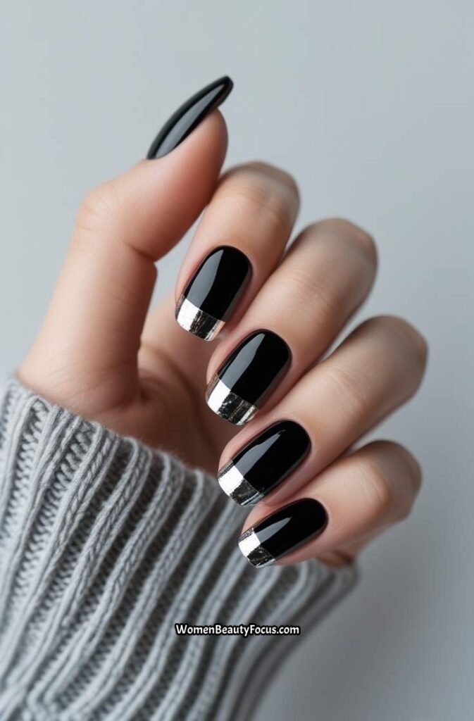 5. Glossy Black Nails with Silver Foil Accents