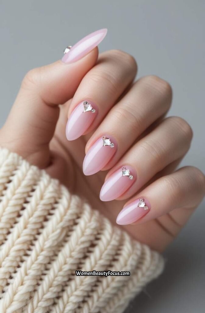 6. Soft Pink Almond Nails with Crystal Embellishments