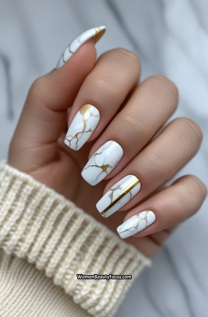 6. White Marble Nails with Gold Touches