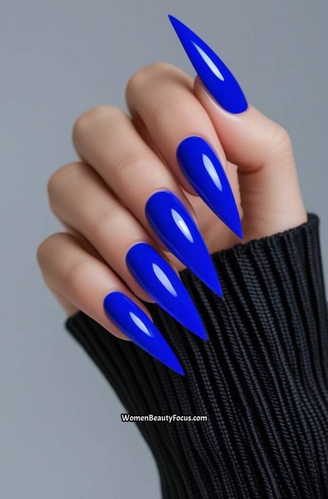 7. Bold Royal Blue Stiletto Nails