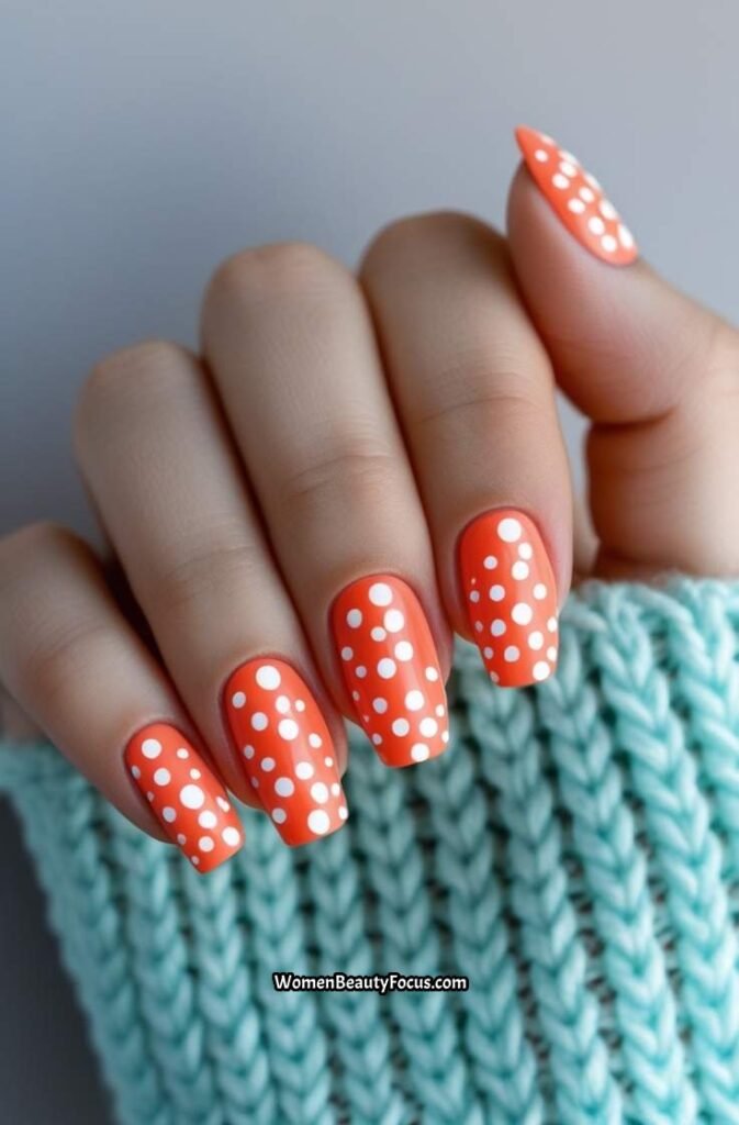 7. Coral Nails with White Polka Dots