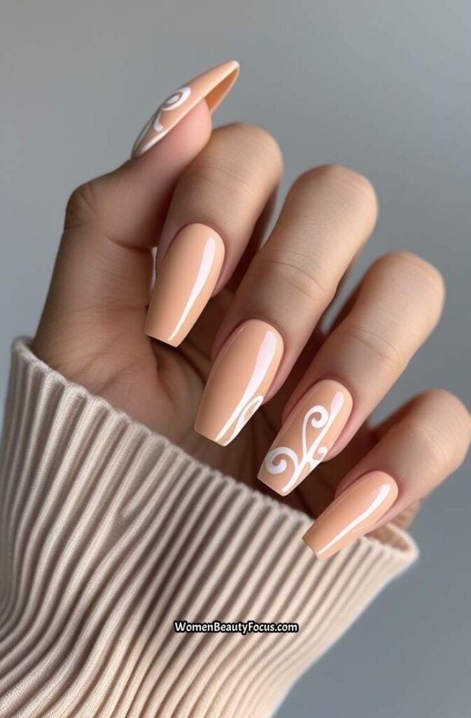 7. Peach Coffin Nails with White Swirls