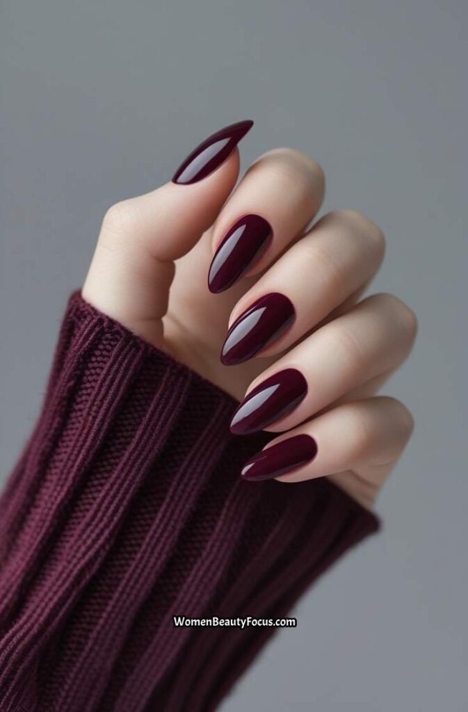 8. Deep Burgundy Glossy Almond Nails