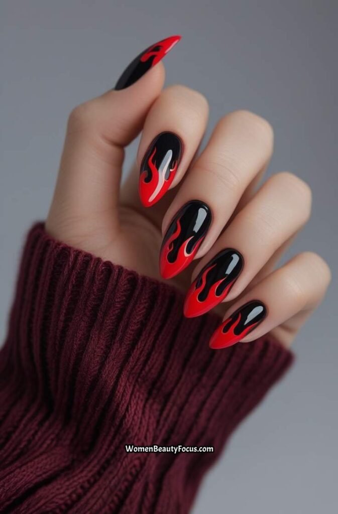 8. Glossy Black Nails with Red Flame Tips
