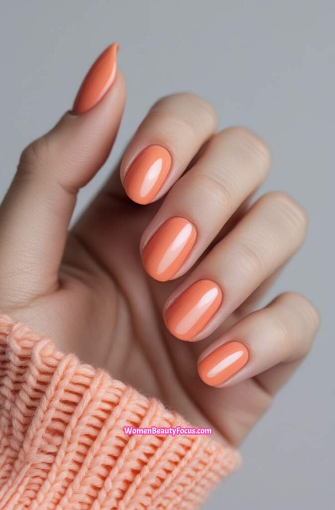 8. Soft Coral Nails with a Glossy Shine
