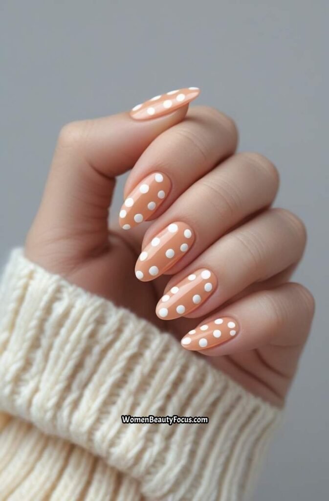 8. Soft Peach Nails with White Polka Dots